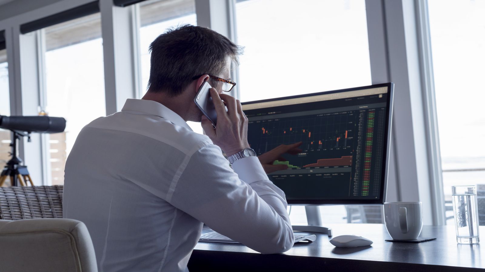 A trader monitoring volatile market charts with focus and composure